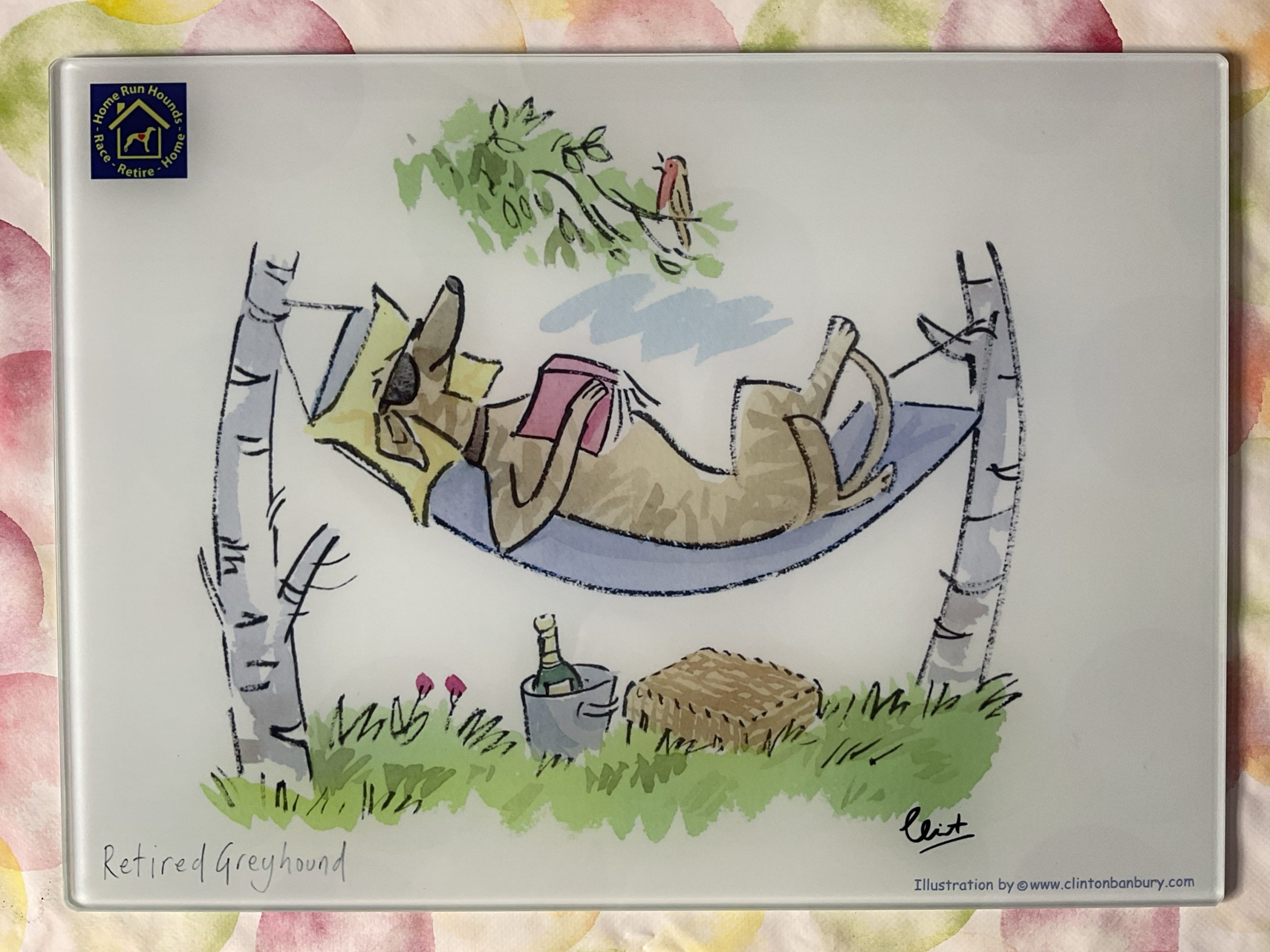Retired Greyhound lazing on a hammock chopping board