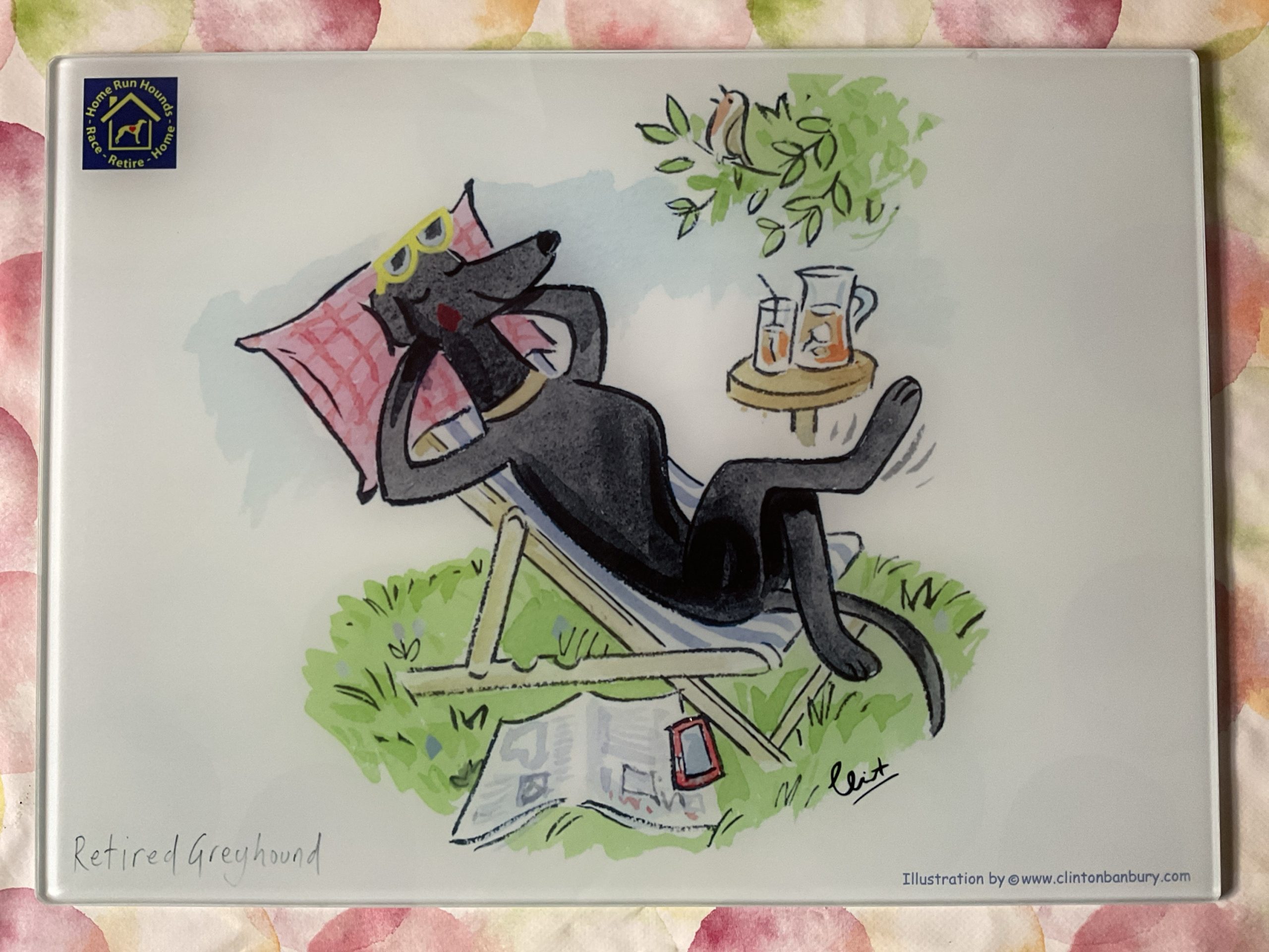 Retired Greyhound in deckchair with Pina Colada chopping board